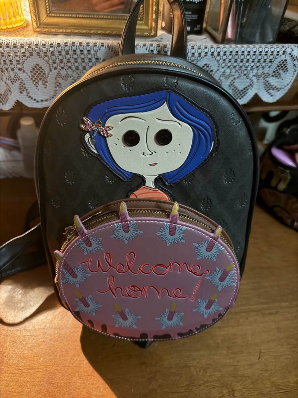Black Backpack with Coraline Character and Pink Front Pocket